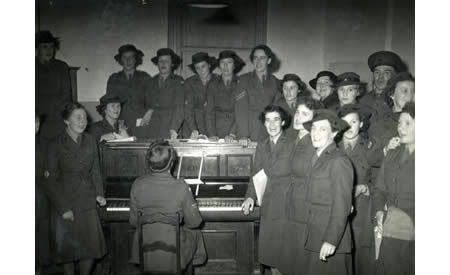 AWAS members around the piano, c 1942. Noel Grace was extremely talented. Courtesy Elsie Solly