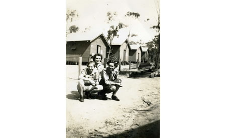 Elsie Solly and friends Ivy and the YMCA representative outside four of the huts where the AWAS was barracked, c 1942. Courtesy Elsie Solly
