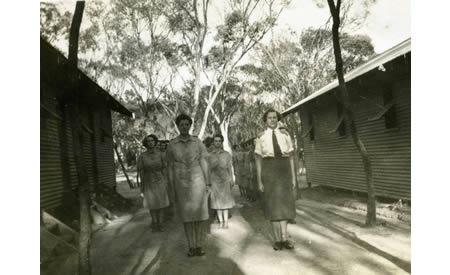 Elsie Solly and comrades standing between barracks on morning parade before starting work at 8am. Courtesy Elsie Solly